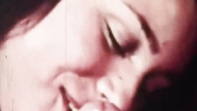 Closeup of smiling brunette woman with sultry eyes in adult video