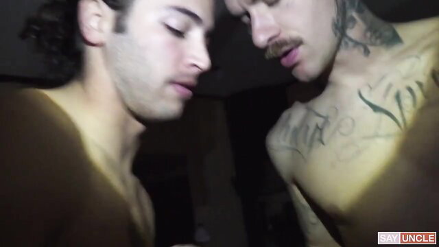 Two hot tattooed guys close-up in Pool Bottoms by Pig Bottoms