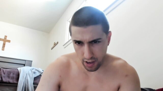 Shirtless Latino man with buzzcut smirking closeup in amateur gay porn thumbnail