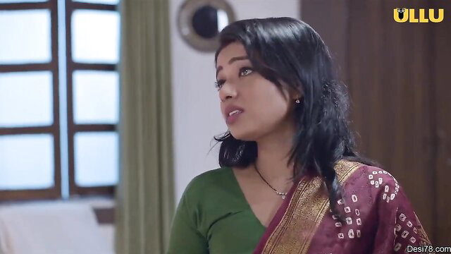 Indian bhabhi in green blouse and maroon saree, seductive gaze