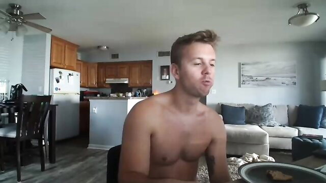 Nude twink guy with freckles eating shirtless in kitchen