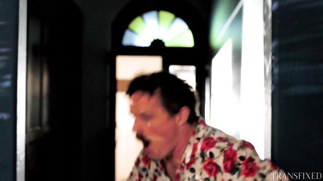 Man in floral shirt yells at cheating trans girlfriend in hallway