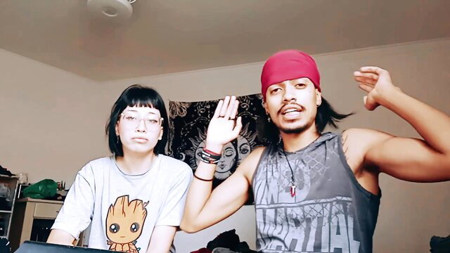 Mixed couple amateur POV reaction: goth girl with glasses and dreadlocked pirate guy waving