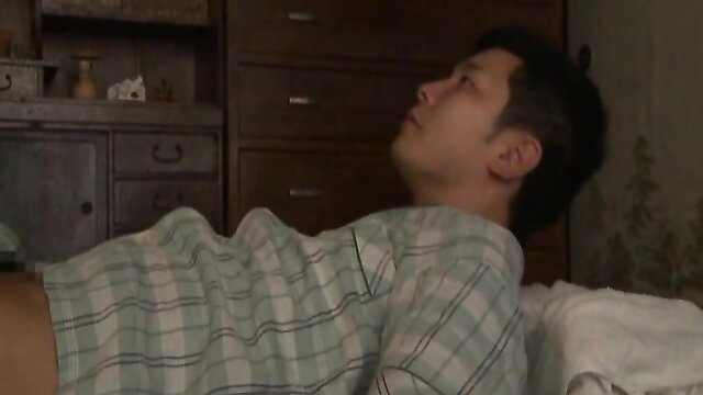 Japanese man in tight plaid shirt bulging on bed, JAV stepmom vibe