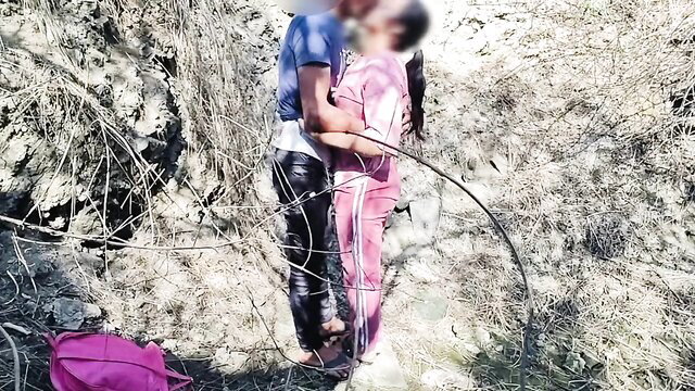 Indian desi school girl in pink tracksuit kissed by guy in jungle outdoors