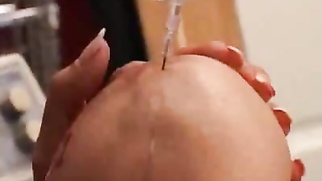 Woman injecting long needle into bald man's head in hardcore torture