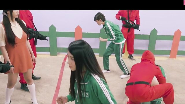 Squid Game porn parody: Asian girls in green tracksuits with guards, guns