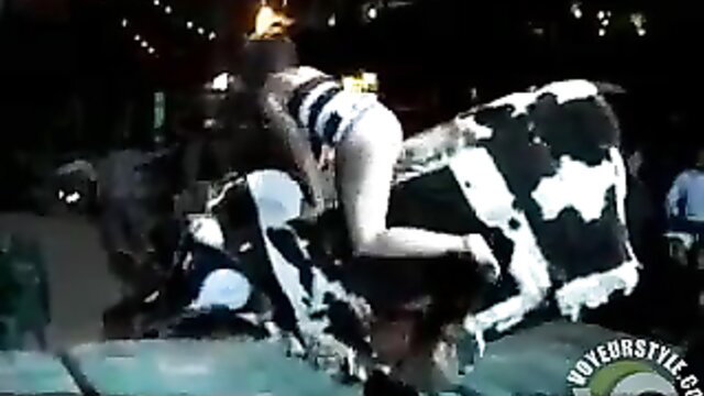 Hot chick rides mechanical bull, flashing naked ass in bikini