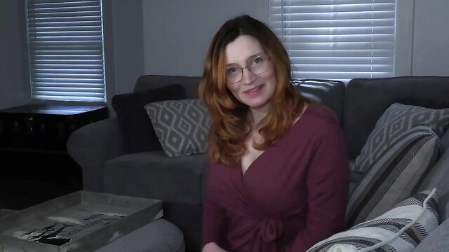 Bettie Bondage redhead step-mom in sexy wrap dress smiles seductively