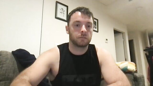 Muscular dirty blond guy in tank top, intense stare, gay amateur thumbnail