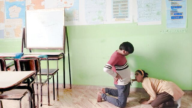 Indian boy bent over as college girl kneels behind in classroom tease