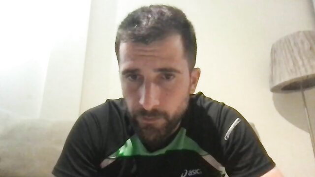 Muscular bearded guy in gym shirt, intense gaze, gay solo thumbnail