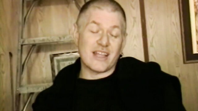 Bald vintage MILF in black top laughs in fruity adult video thumbnail