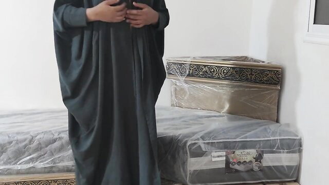 Salma Arabic veiled MILF in abaya standing by beds, hot ass tease