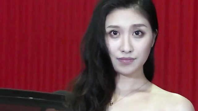 Asian beauty with long black hair in red bondage stage setup