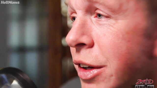 Closeup of sensual MILF with red hair speaking passionately in adult video