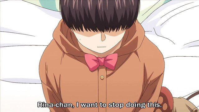 Cute Japanese girl in bear suit hoodie and bowtie looks sad on bed