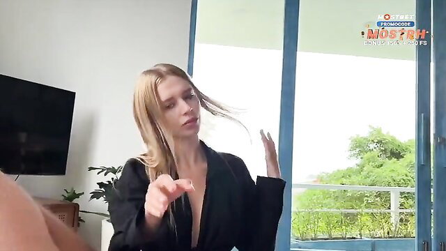 Blonde temptress in deep black blazer flashes cleavage seductively