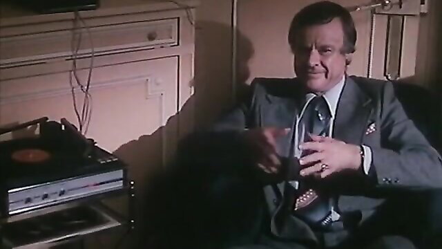 Mature man in suit with drink, classic adult scene thumbnail