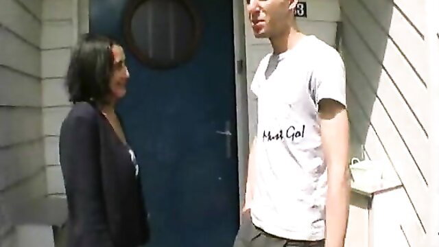 Hairy mature brunette chats with younger guy at door in tight top