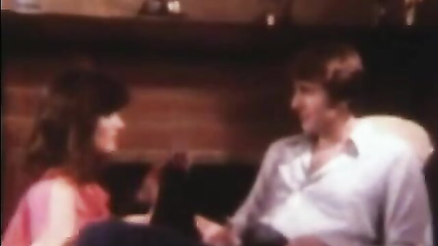 Vintage brunette with big tits chats intimately with shaggy-haired man in classic XXX