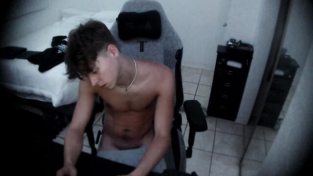 Shirtless twink Jamesoblonde sits nude at desk in gay amateur video thumbnail