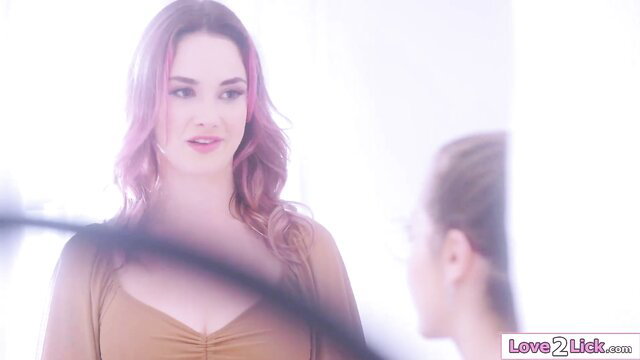 Flower girl with pink wavy hair poses in cleavage-revealing lingerie