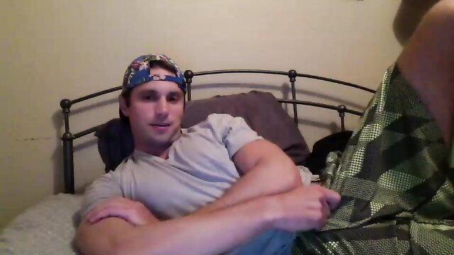 Muscular white guy in cap and tee lounging on bed in gay amateur thumbnail