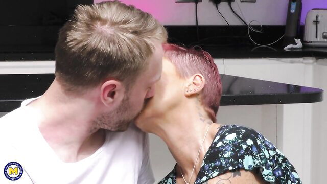 Pink Haired Mature Samantha Kisses Guy in Kitchen Tease