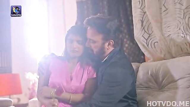 Indian couple embracing on a couch
