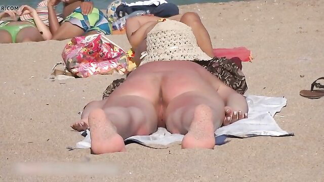 Young brunette fully nude on beach, big ass up sunbathing