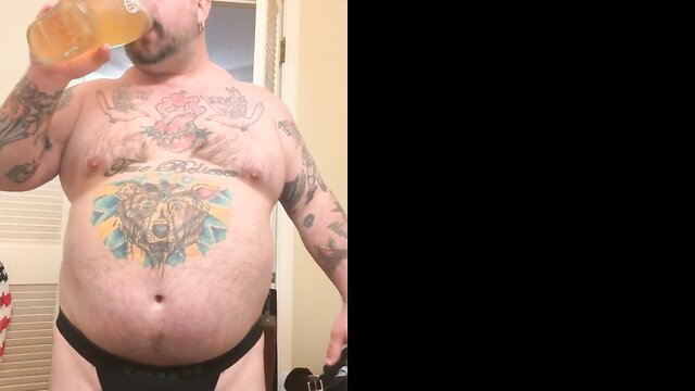 Hairy redneck daddy bear chugs beer in black thong