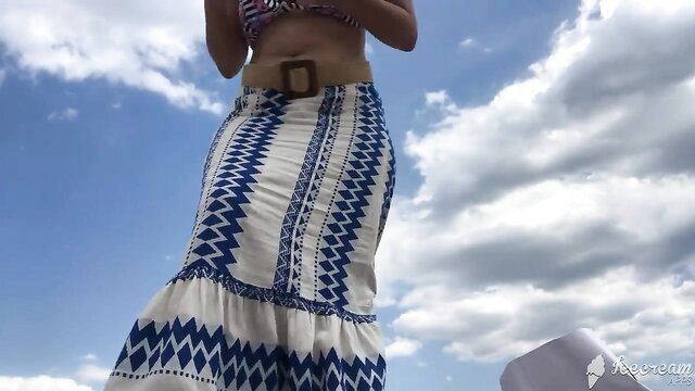 Tsetsi shows off huge tits in bikini and skirt on sunny beach