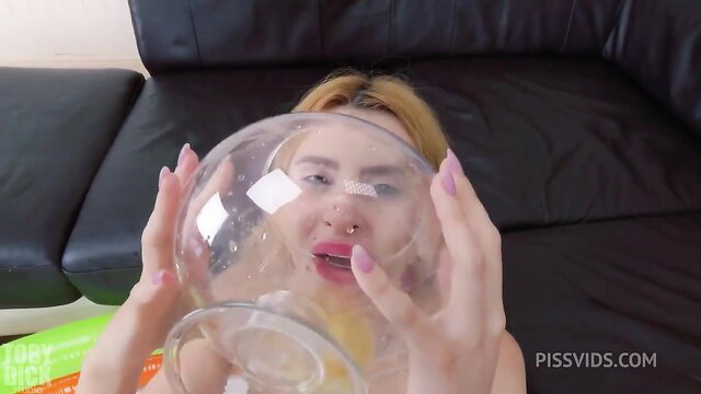 Blonde babe holding glass bowl, ready for piss drinking anal fun