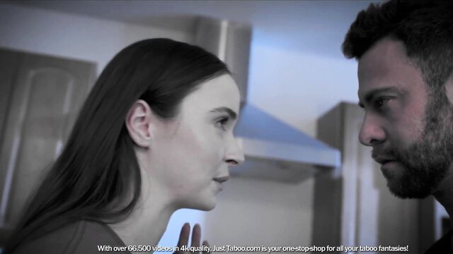 Brunette woman in tense talk with bearded man in kitchen, adult drama tease