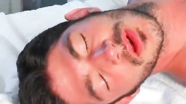 Hot bearded Latino hunk lying back eyes closed lips parted in ecstasy