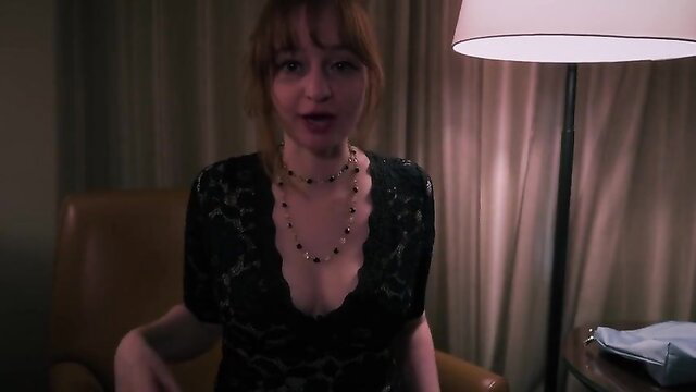 Delilah Cass in sexy black lace dress, teasing cleavage