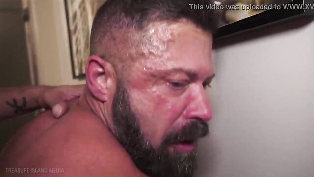Masculine papa bear with beard sweating in intense gay poppers scene