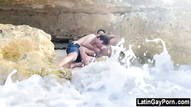 Two hot Latino guys fucking outdoors on sunny beach rocks