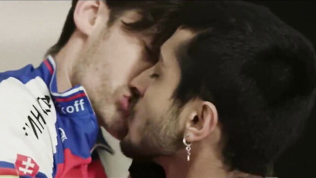 Two men kissing, one wearing a Slovakian sports jersey