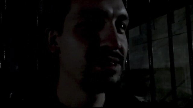 Shadowy Latino man with beard stares intensely in dark amateur gay anal thumbnail