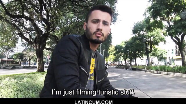 Latino guy in black jacket says 'I'm just filming tourist stuff' outdoor POV