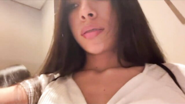 Hot brunette with tongue out in low-cut top, caught squirting in store fitting room