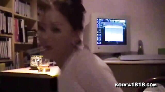 Horny Korean MILF in white blouse at desk with whiskey glass