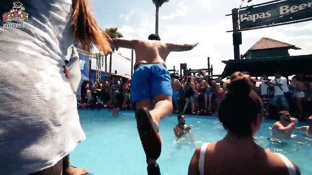 Shirtless hunk dives into pool at wild college beach orgy party