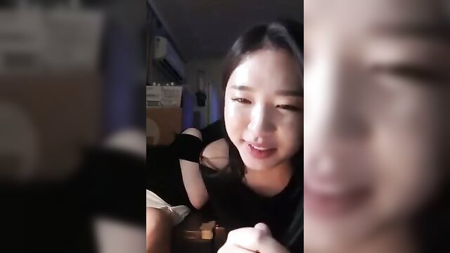 Closeup of cute Korean girl smiling in low-cut black top, amateur thumbnail