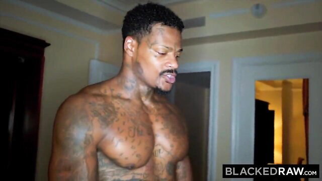 Tattooed black stud flexing ripped muscles in Blacked Raw interracial preview