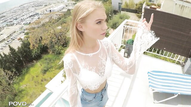 Dreamy blonde Nancy Ace in sheer lace top on balcony