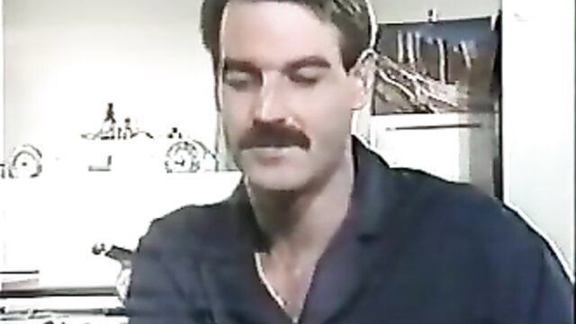 Handsome mustached man in dark shirt, closeup portrait
