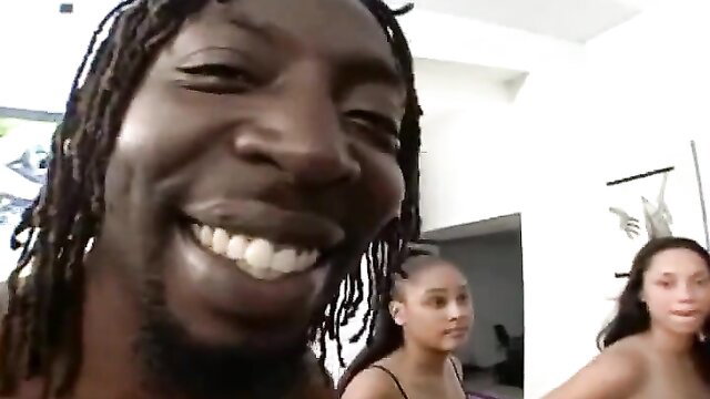 Black dude grinning with two smiling mixed black teen girls in Big Black Booty Orgy